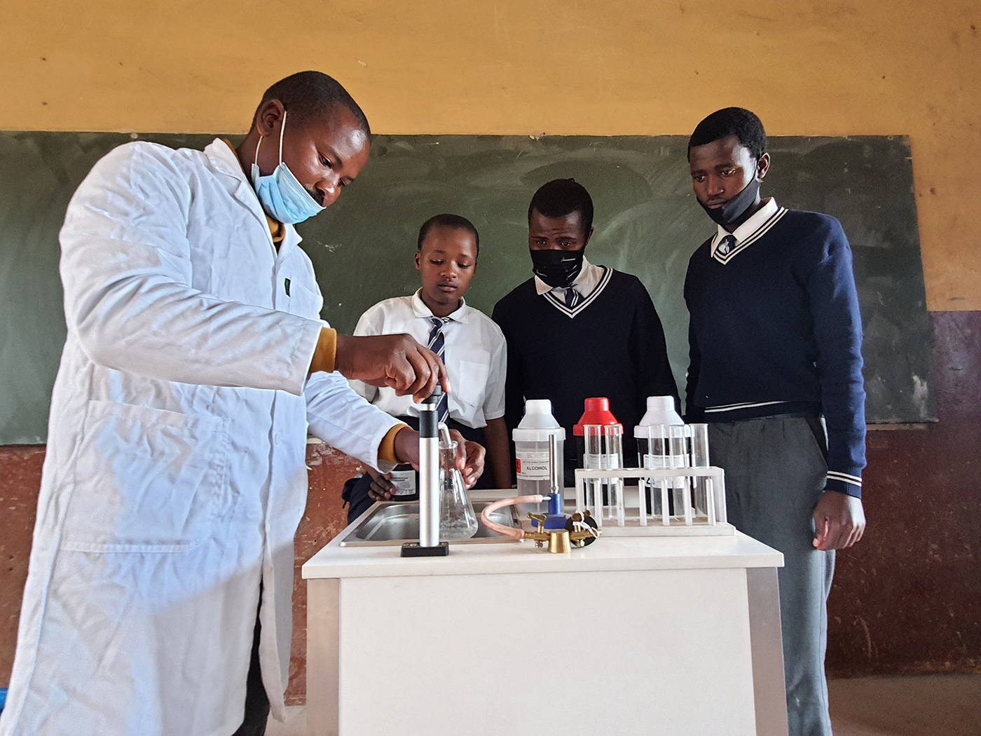 Anele Mbiko, the physical and life science teacher at Ntukayi Senior Secondary School, with Grade 12 learners who received science kits and math study guides from Wild Coast Sun